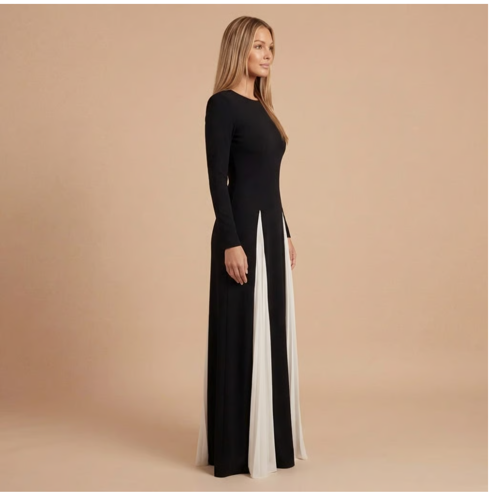 Side profile of women's black and white maxi dress with long sleeves and flowing skirt