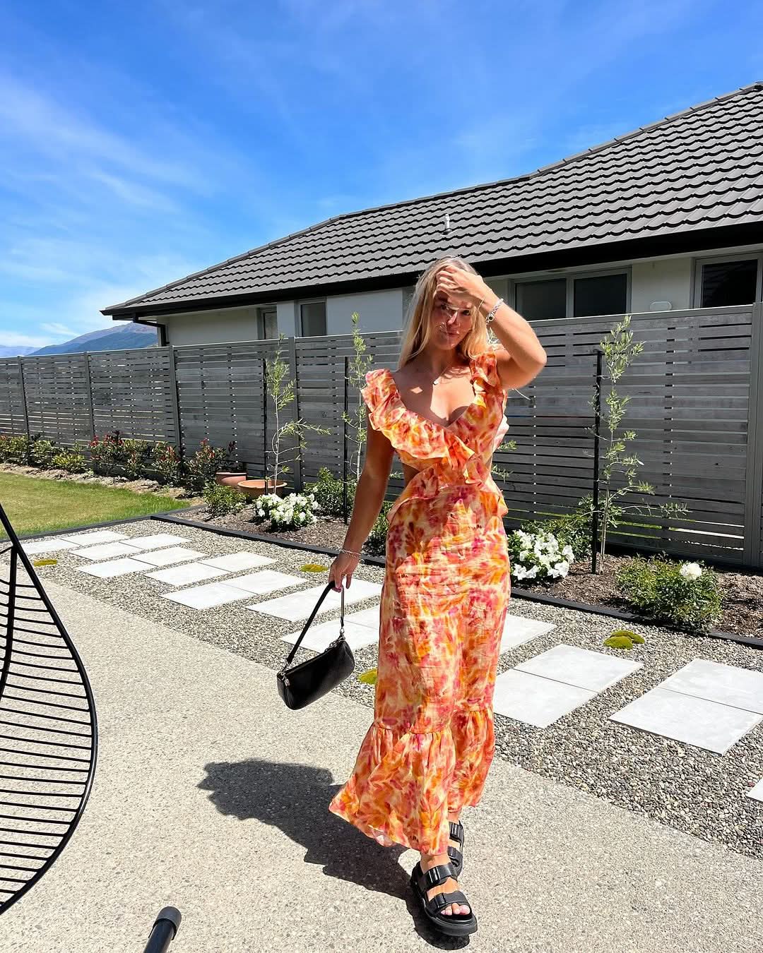 Women watercolor floral maxi dress outdoor styling with ruffled V-neck and open back