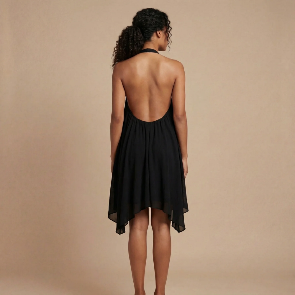 Black halter mini dress back view showing open back design and asymmetric hemline