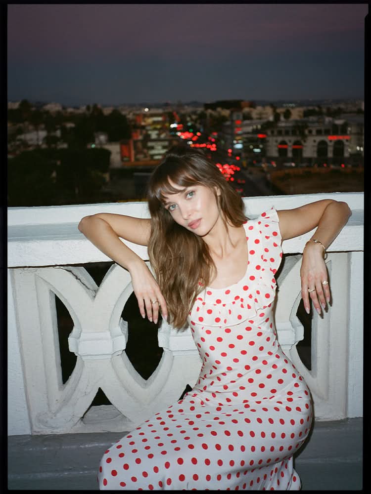 White polka dot maxi dress ruffled neckline back detail view evening setting