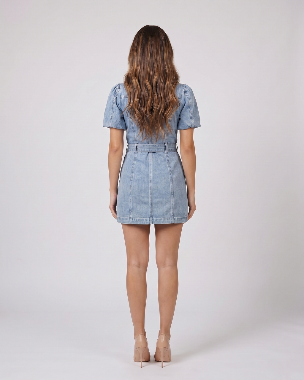 Back view of blue button front collared puff sleeve mini dress showing solid back