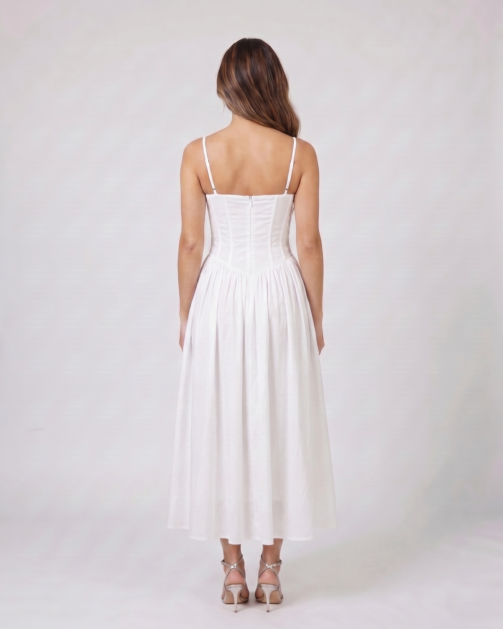 Back view of white floral strapless corset midi dress showing solid back with center back zipper closure