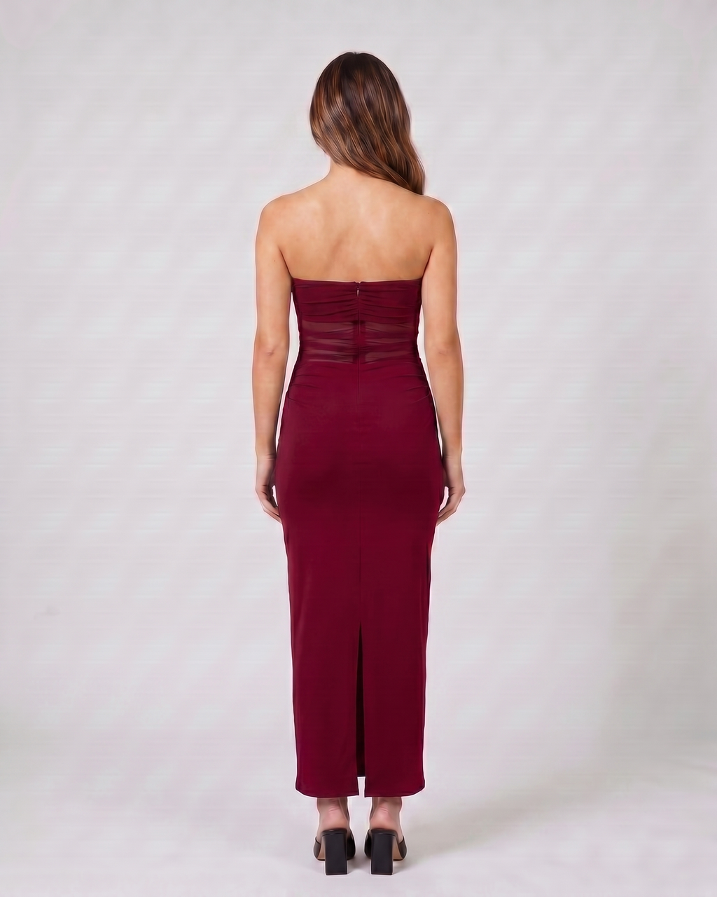 Back view of burgundy strapless bodycon with scarf maxi dress showing solid back with concealed center back zipper and center back slit at hem