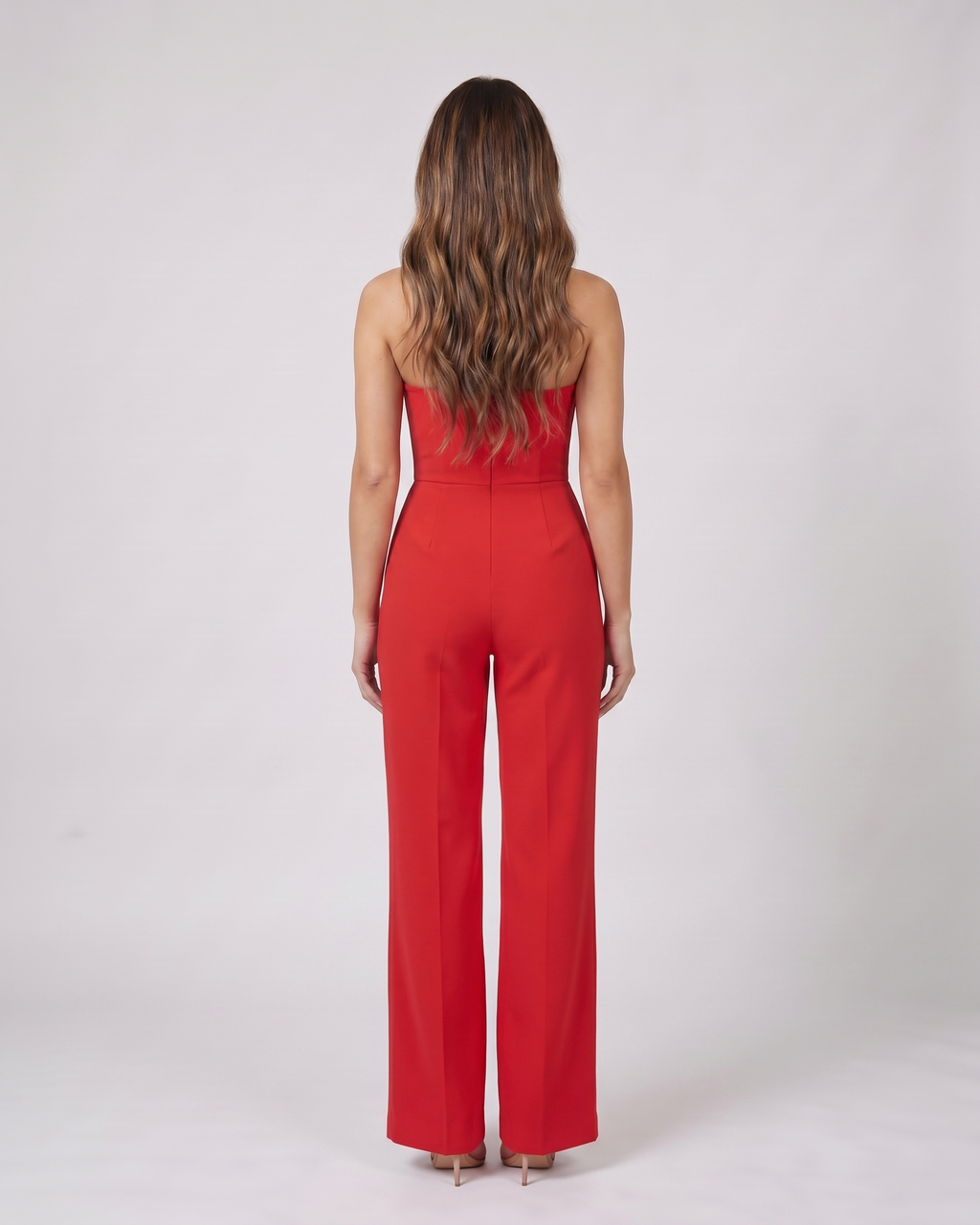 Back view of red strapless sweetheart wide leg formal jumpsuit showing not visible