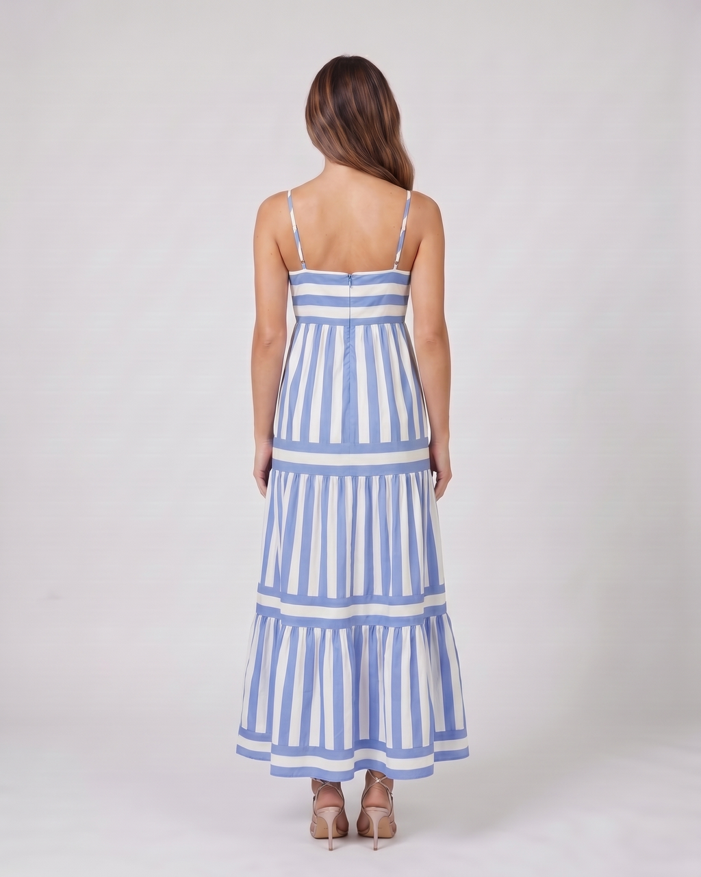 Back view of blue striped spaghetti strap maxi dress showing solid back with invisible zipper closure