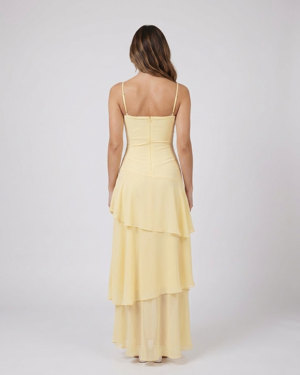 Back view of yellow sweetheart spaghetti strap tiered maxi dress showing solid, concealed zipper closure, spaghetti strap