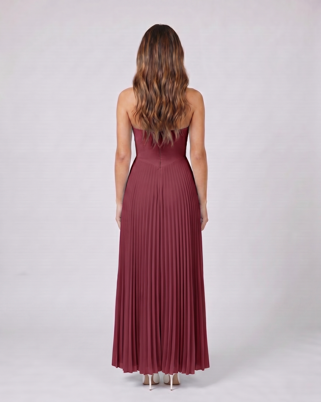 Back view of claret sweetheart strapless pleated maxi dress showing solid back with center zip closure