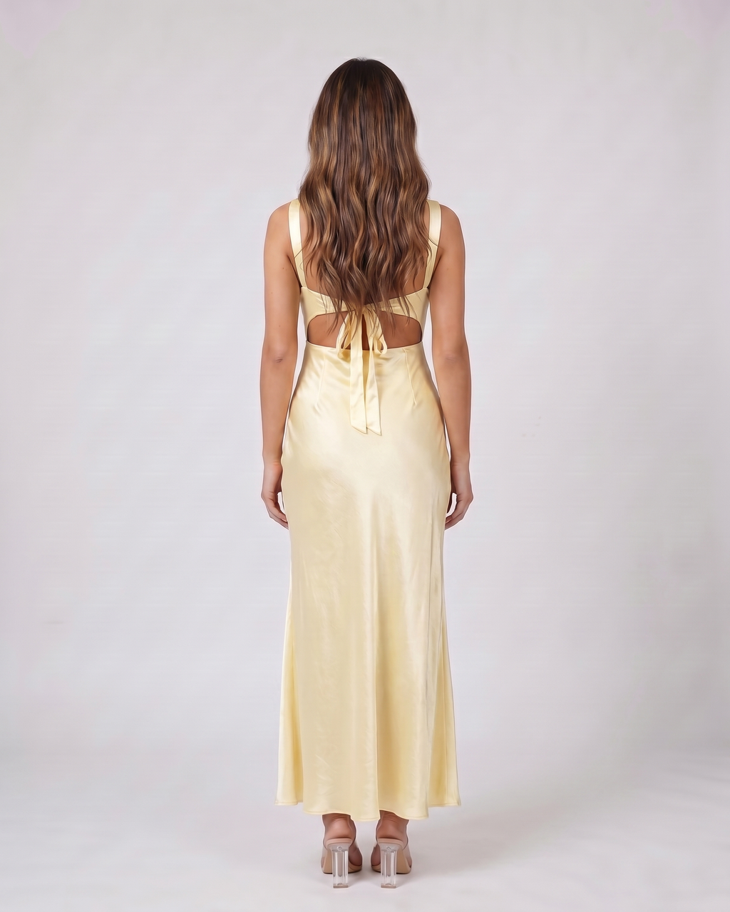 Back view of yellow wedding guest square neck maxi dress showing open back with tie closure