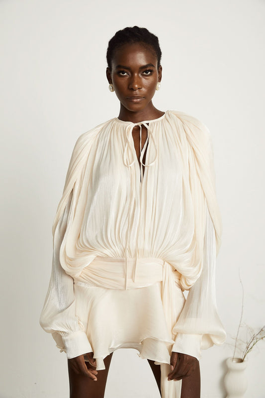 Women cream mini dress with long balloon sleeves, tie keyhole neckline, and pleated bodice front