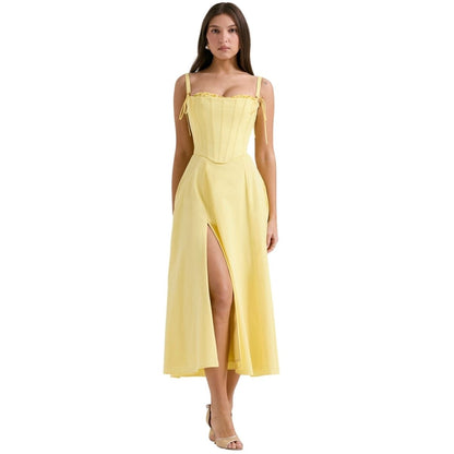 Model wearing the Laarni butter yellow corset midi dress with detachable straps and a front leg slit.