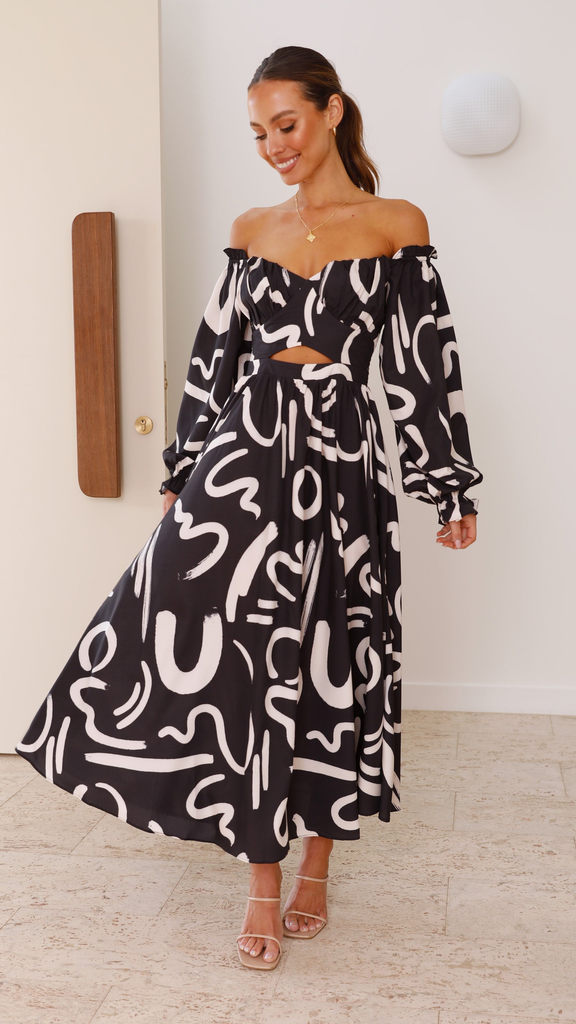 Women abstract print midi dress featuring waist cutout and flowing skirt full length