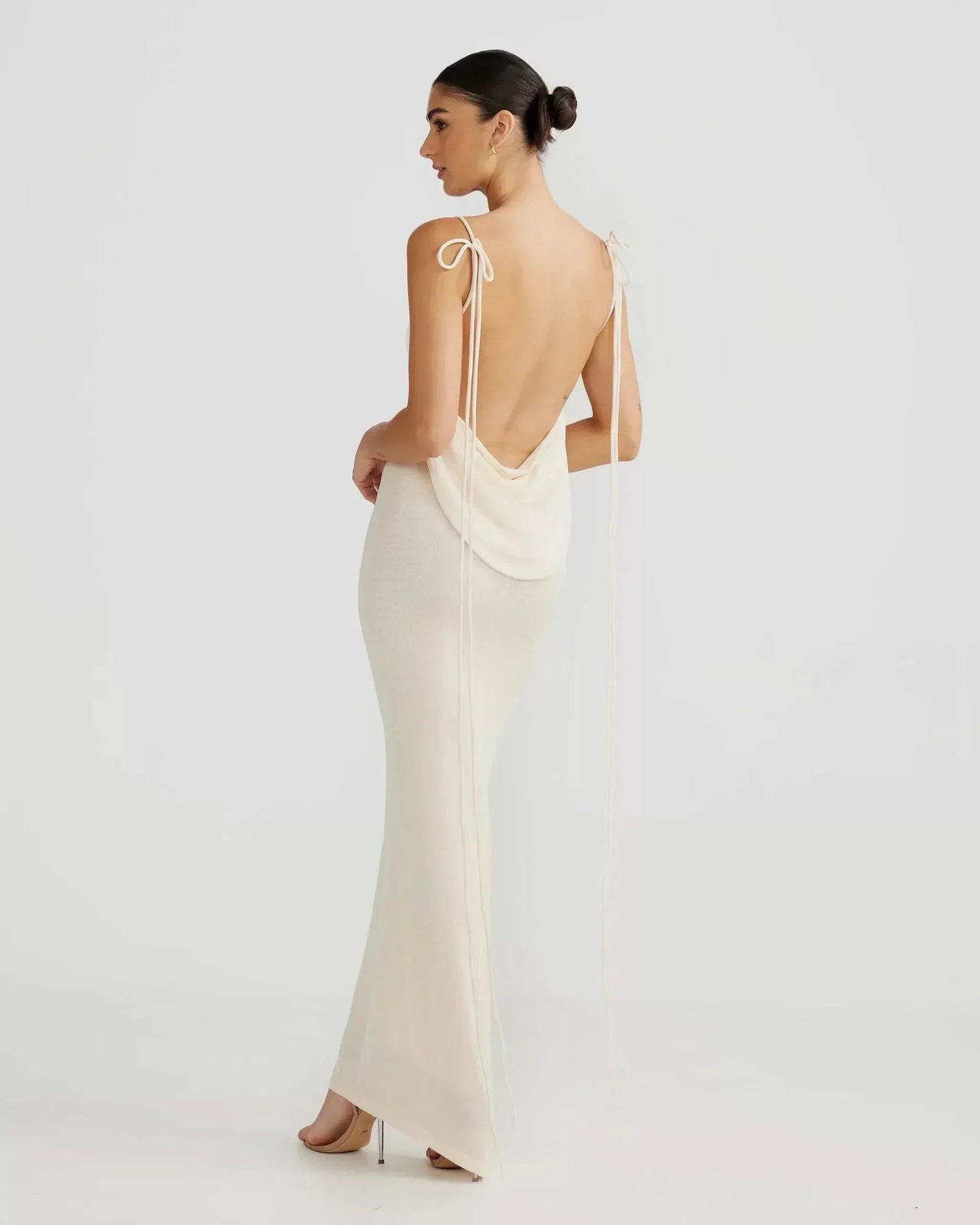 Women cream open back maxi dress with cowl drape and tied shoulder detail, side back view