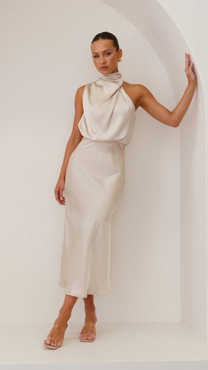 Women sleeveless midi dress side view showing fitted midi-length skirt and draped bodice