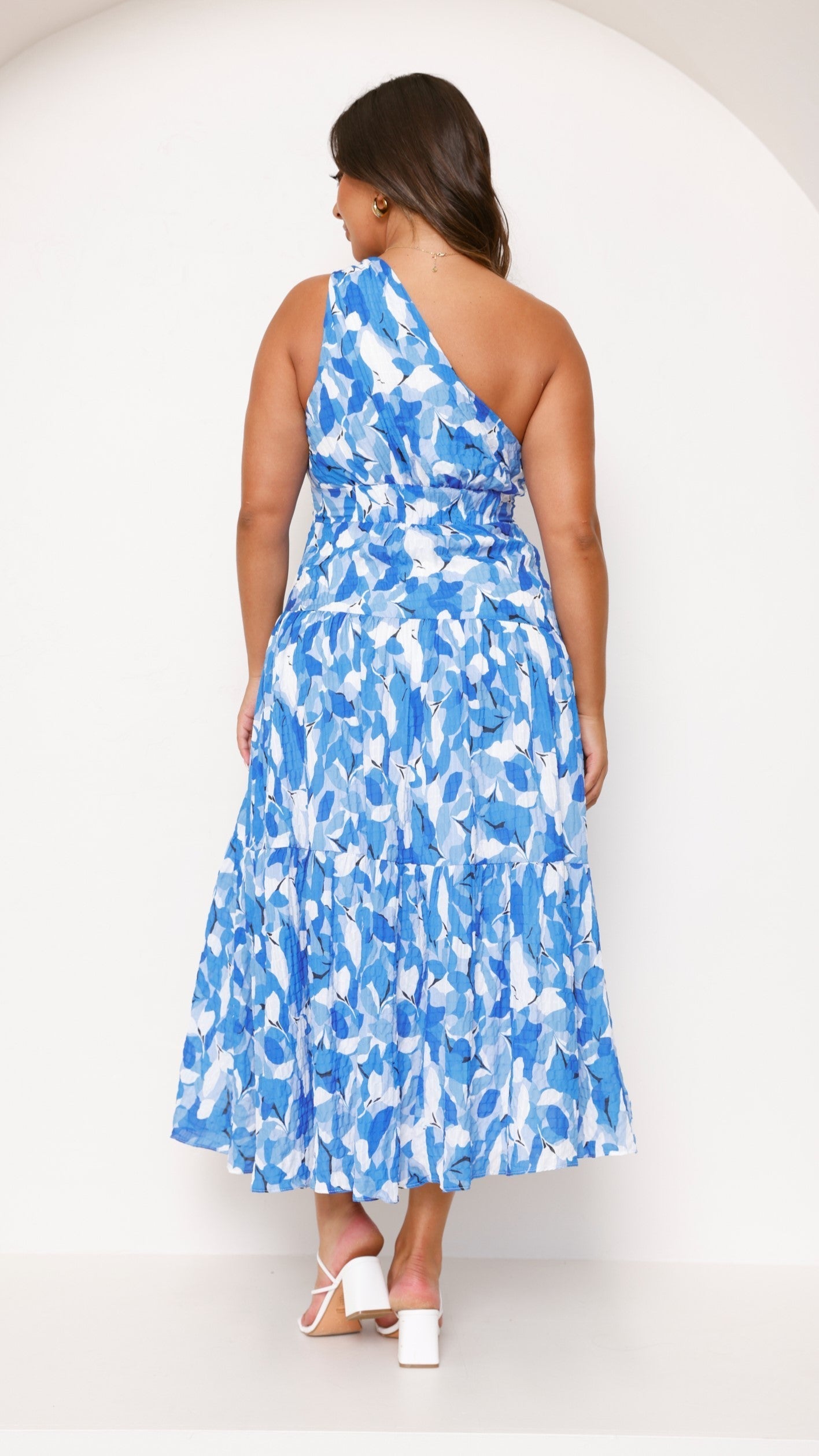 Women blue and white floral tiered midi dress back profile with knotted shoulder strap