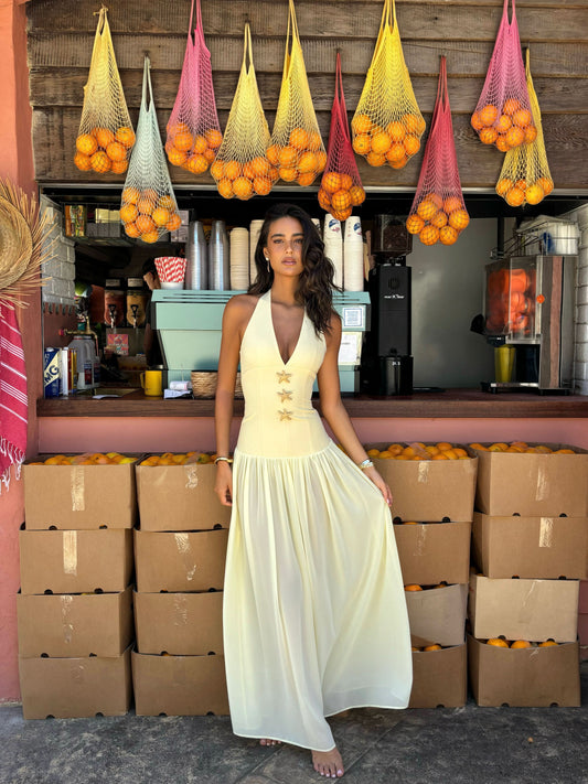 Women cream halter maxi dress with deep V-plunge neckline and starfish embellishments