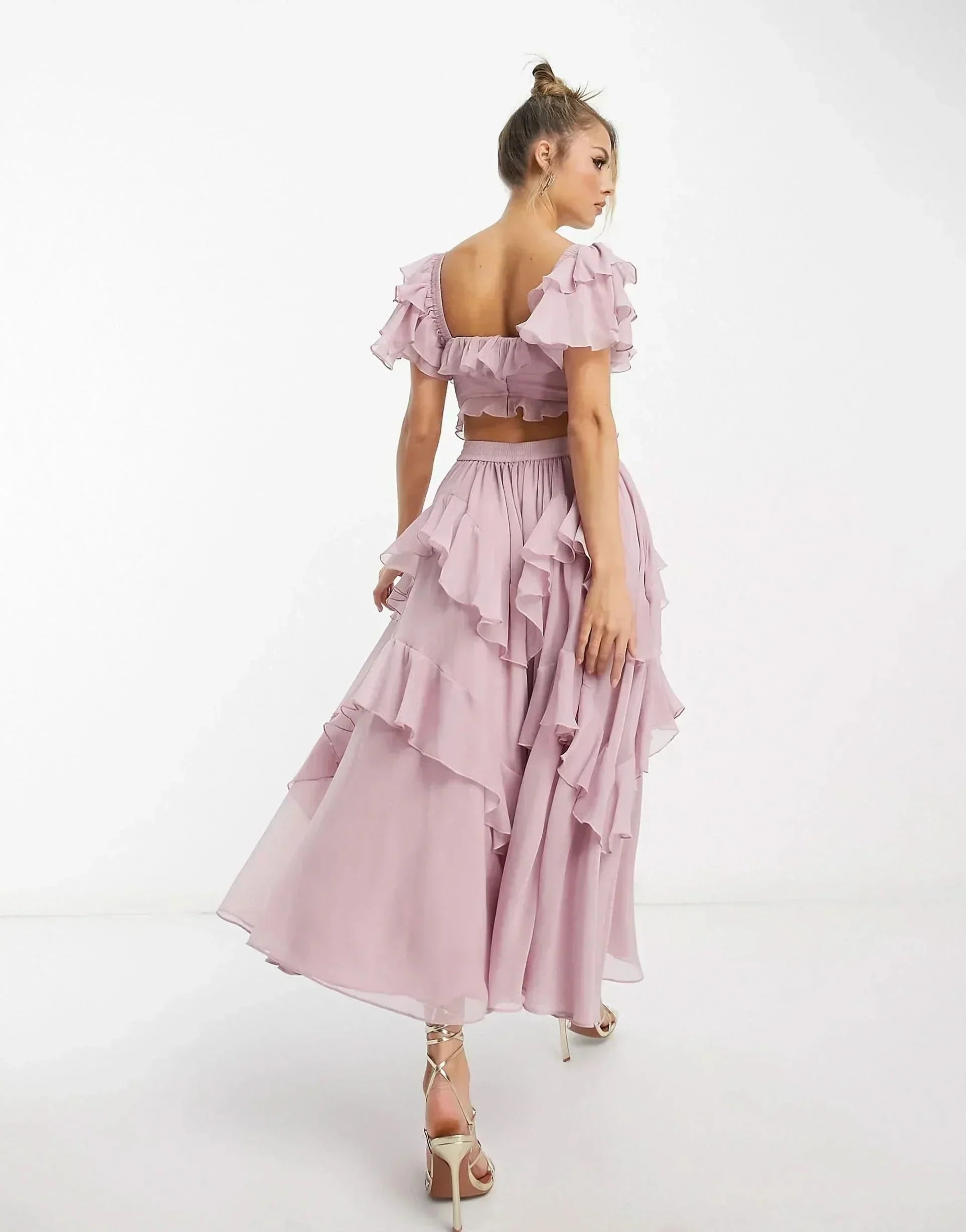 Back view of pink off-shoulder ruffle dress showing open back design