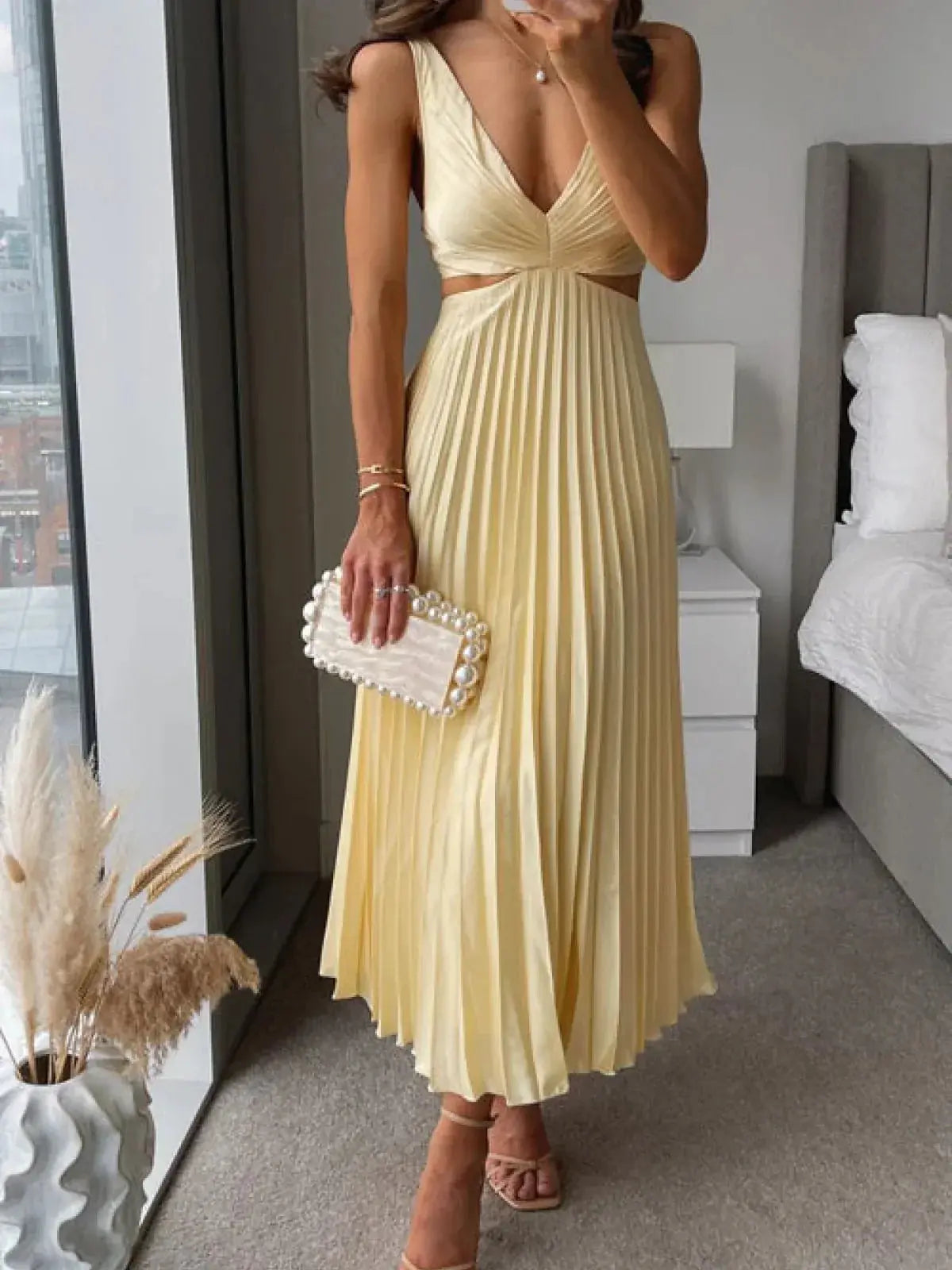 Women cream pleated midi dress with V-neckline and waist cutouts
