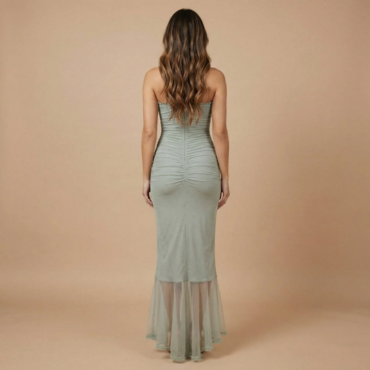 Back view of women maxi dress showing ruched construction and cascading ruffled hem