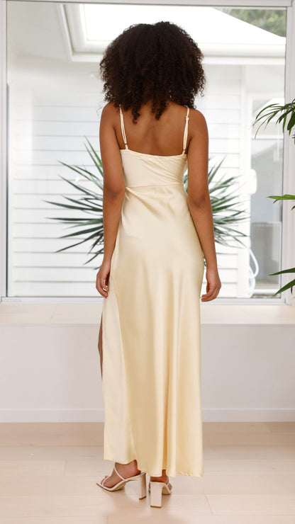 Back view cream satin maxi dress showing spaghetti straps and side slit