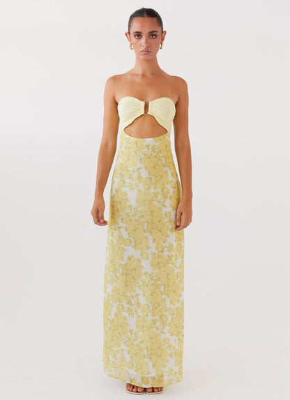 Front view of women's yellow floral maxi dress with ruched bodice and underbust cutout
