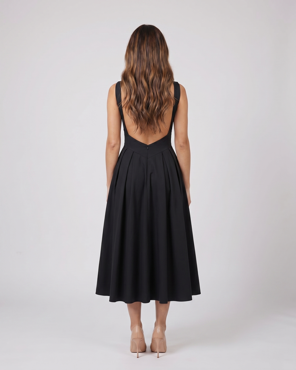 Back view of black boat neck a-line midi dress showing Open back