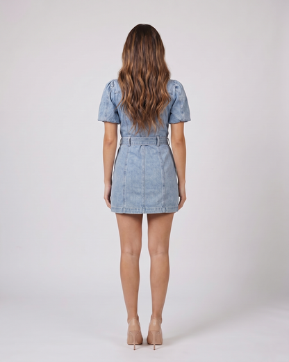 Back view of blue button front collared puff sleeve mini dress showing solid back
