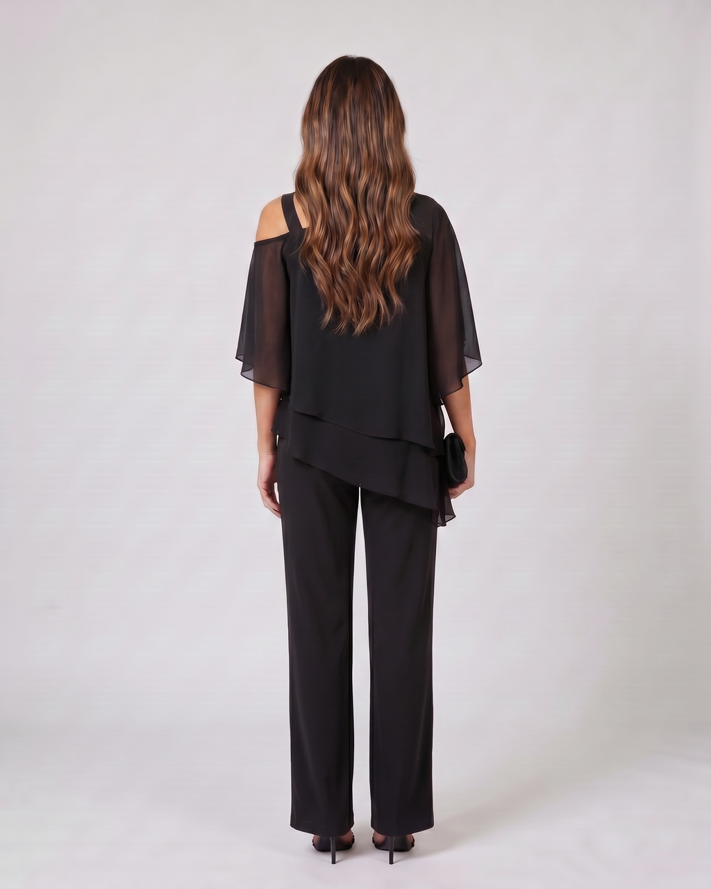Back view of black cold shoulder layered straight leg pant set showing solid back