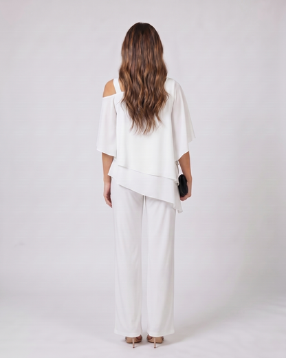 Back view of white cold shoulder layered straight leg pant set showing solid back