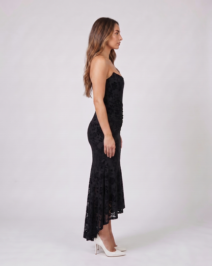 Side view of black floral jacquard strapless high low maxi dress