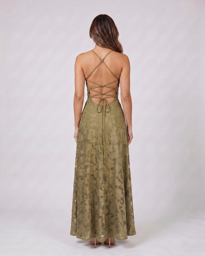 Back view of green floral lace square neck maxi dress showing open back with criss-cross spaghetti straps and tie closure