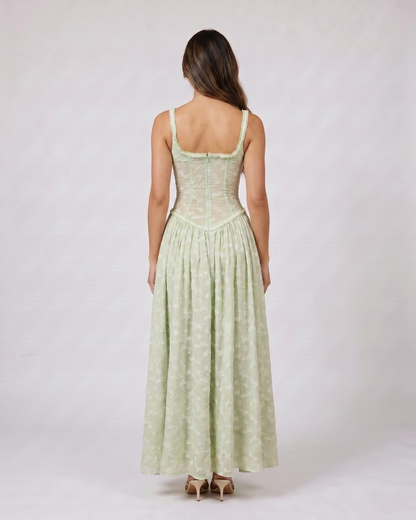 Back view of green floral scoop neck with slit maxi dress showing solid back with scoop neckline