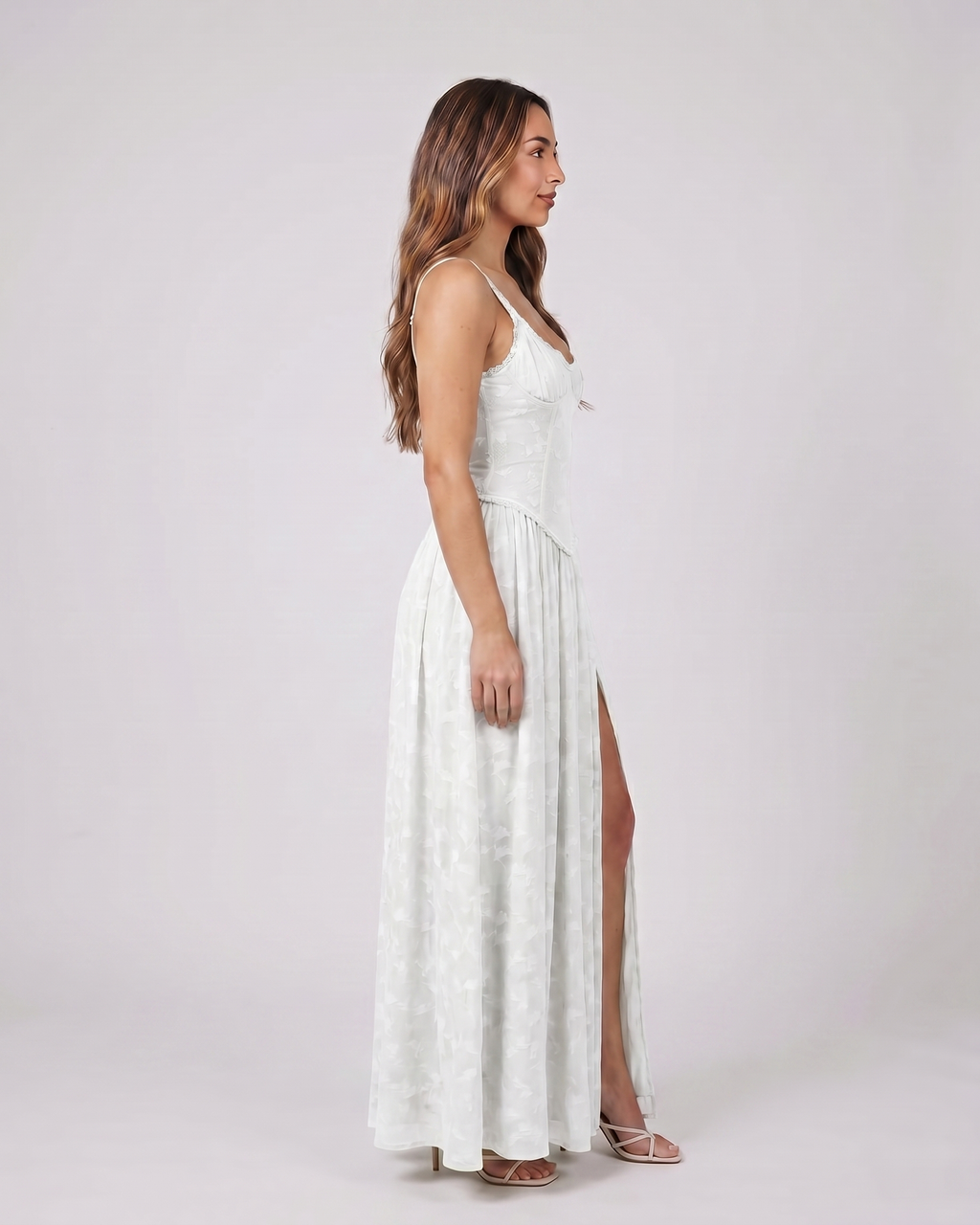 Side view of white floral scoop neck with slit maxi dress