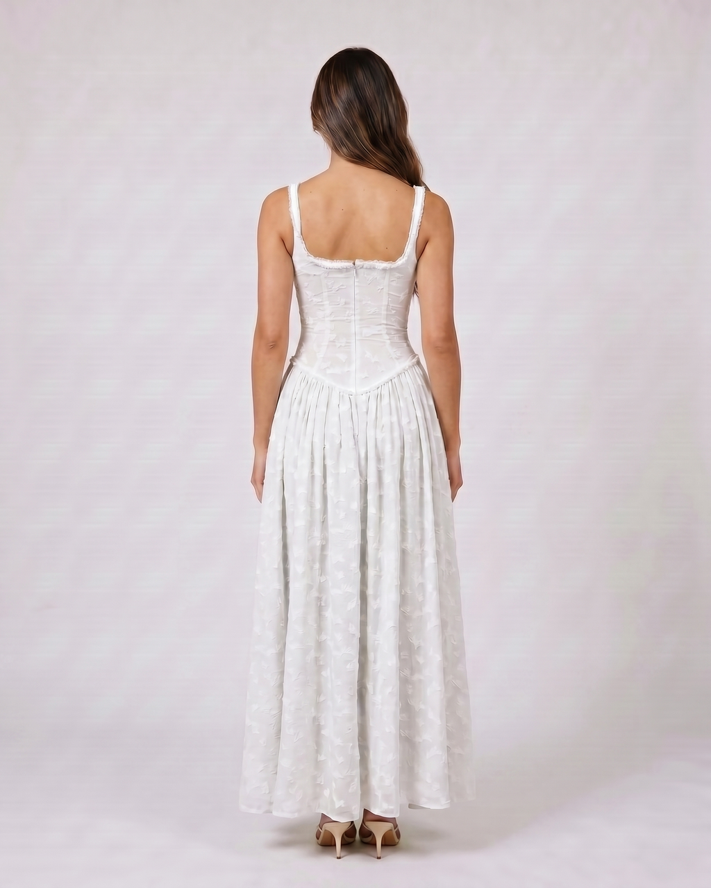 Back view of white floral scoop neck with slit maxi dress showing solid back with scoop neckline and visible corset boning seams