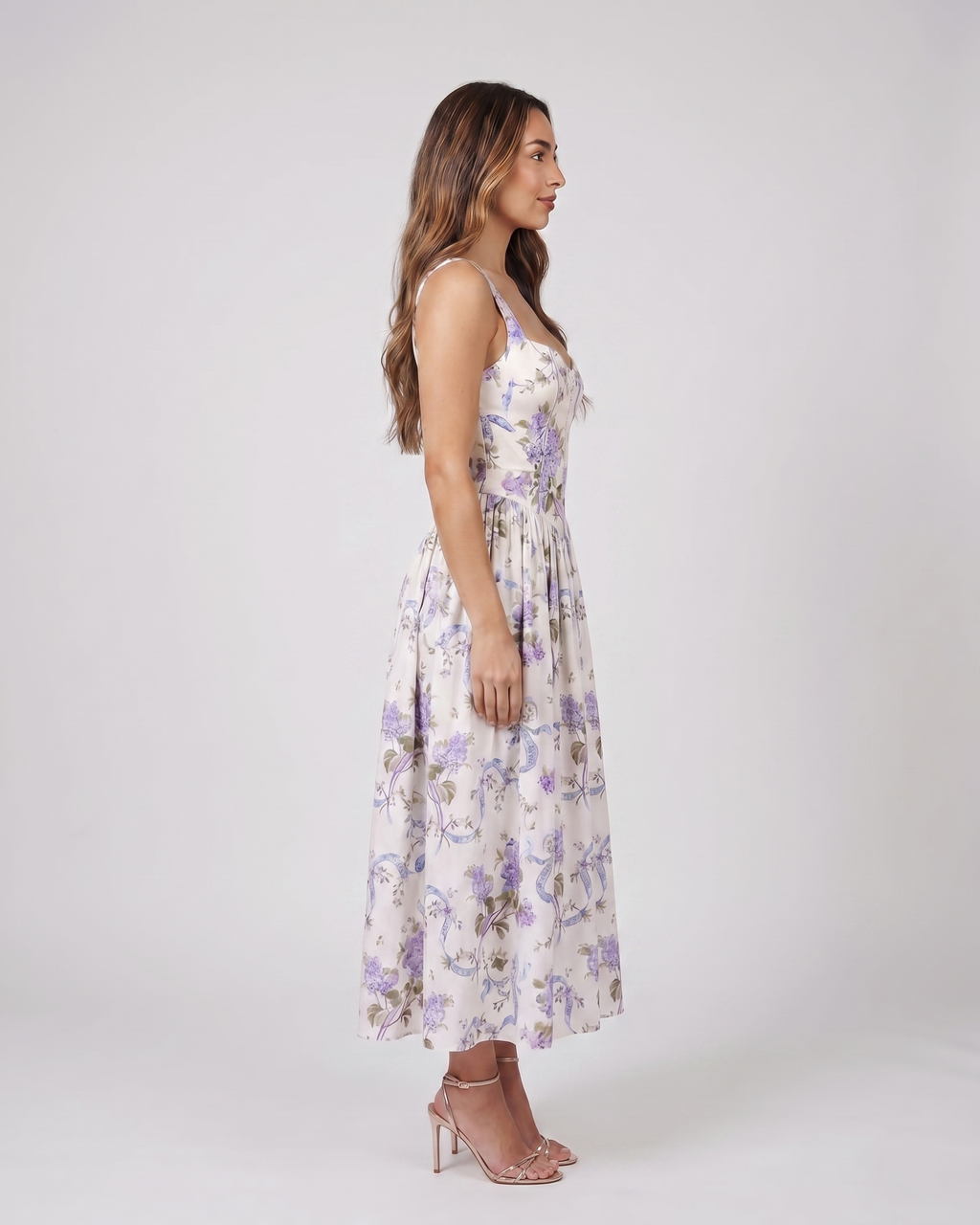 Side view of creamy floral floral strapless corset midi dress