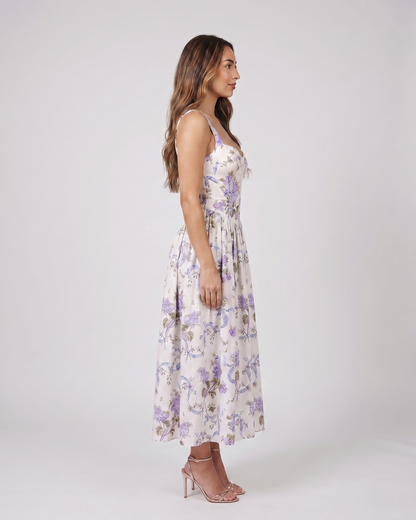 Side view of creamy floral floral strapless corset midi dress