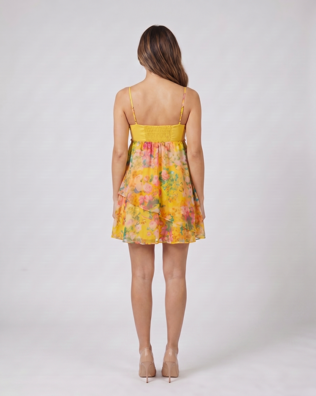 Back view of floral orange floral sweetheart neck spaghetti strap mini dress showing solid back with ruched elasticated panel