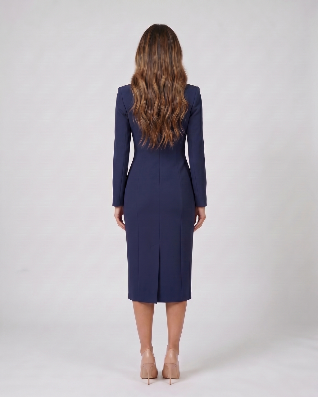 Back view of navy blue formal long sleeve v neck midi dress showing solid back with center back kick vent at hem