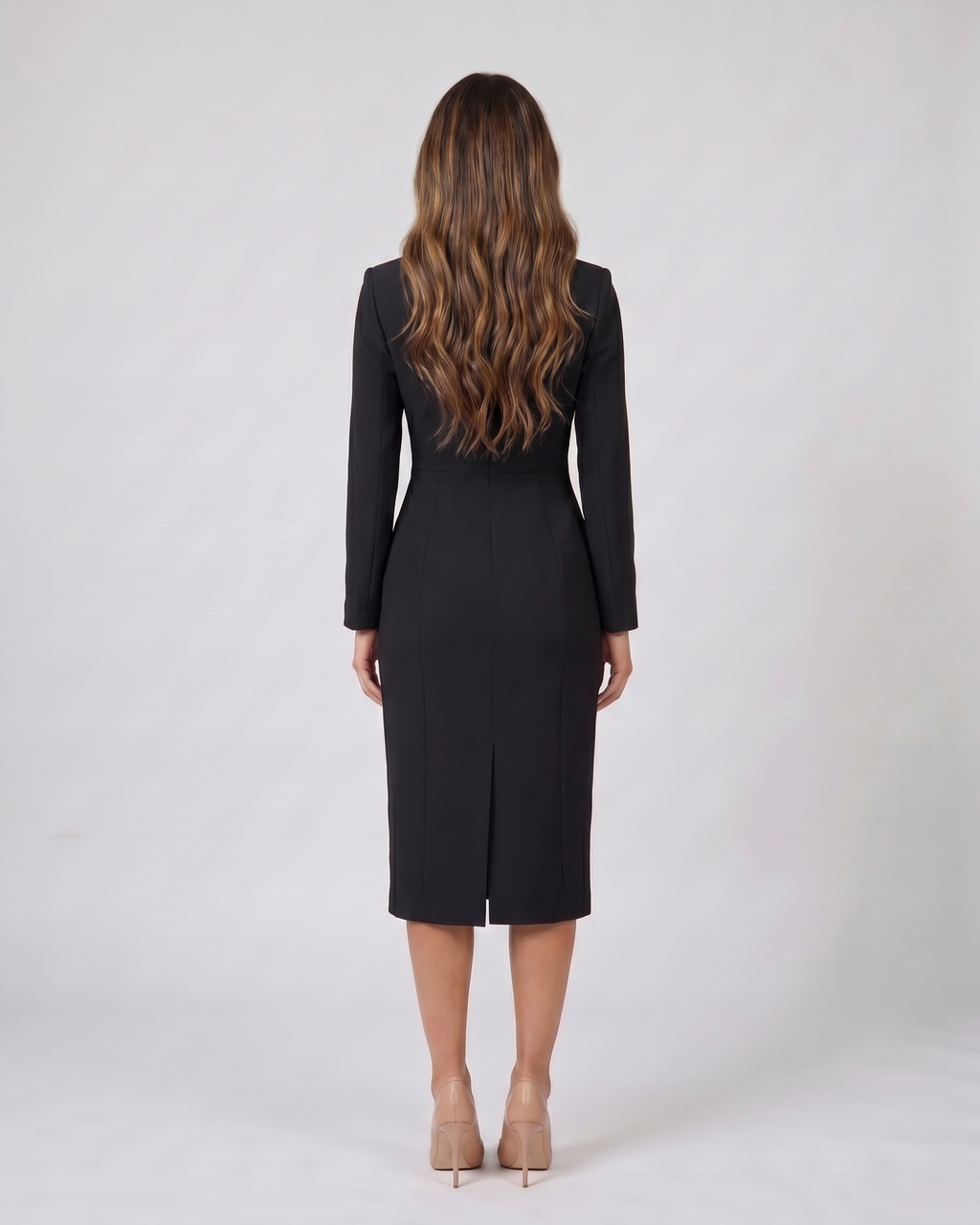 Back view of black formal long sleeve v neck midi dress showing solid back with center back kick vent at hem