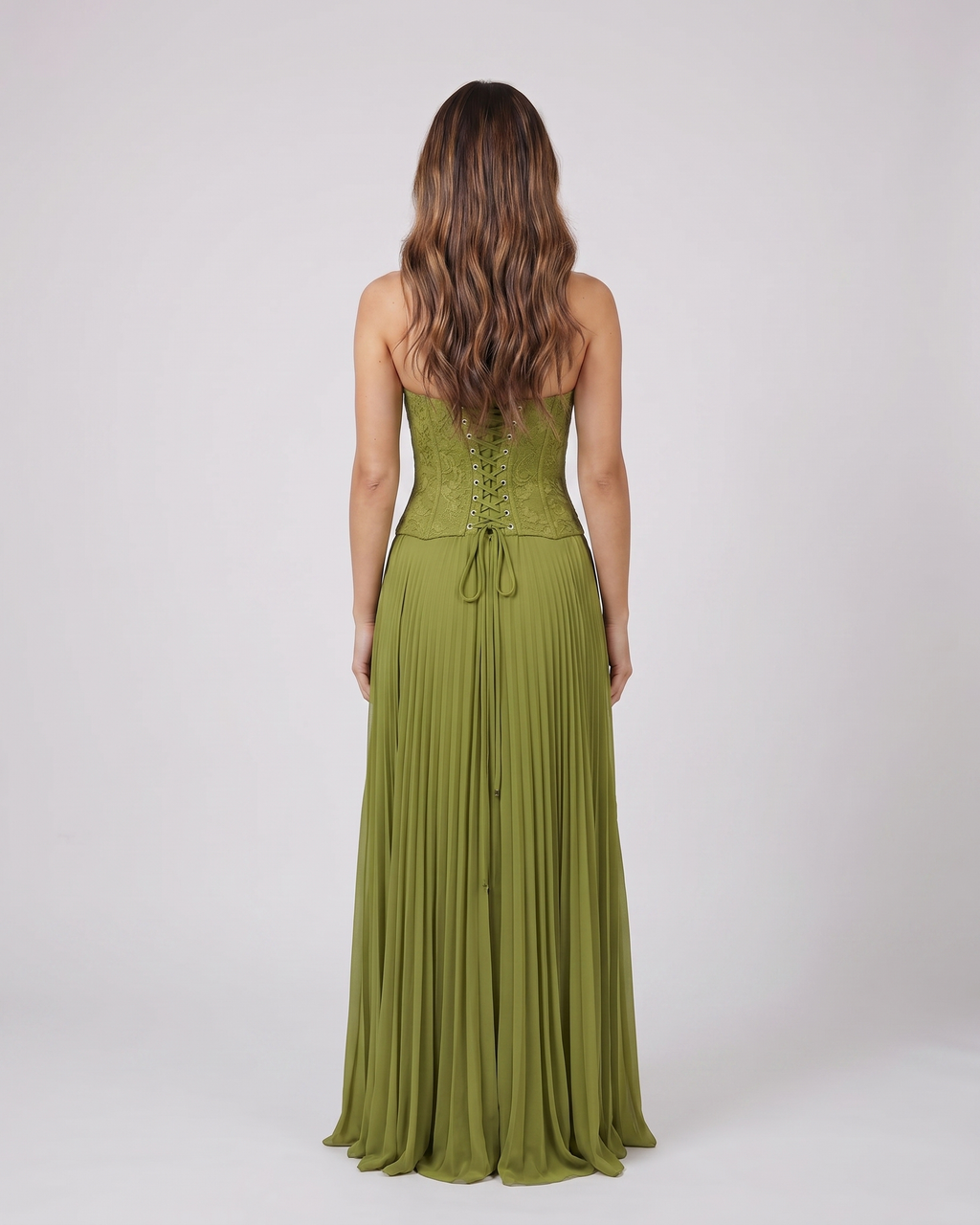 Back view of green formal sweetheart sleeveless maxi dress showing lace-up corset back