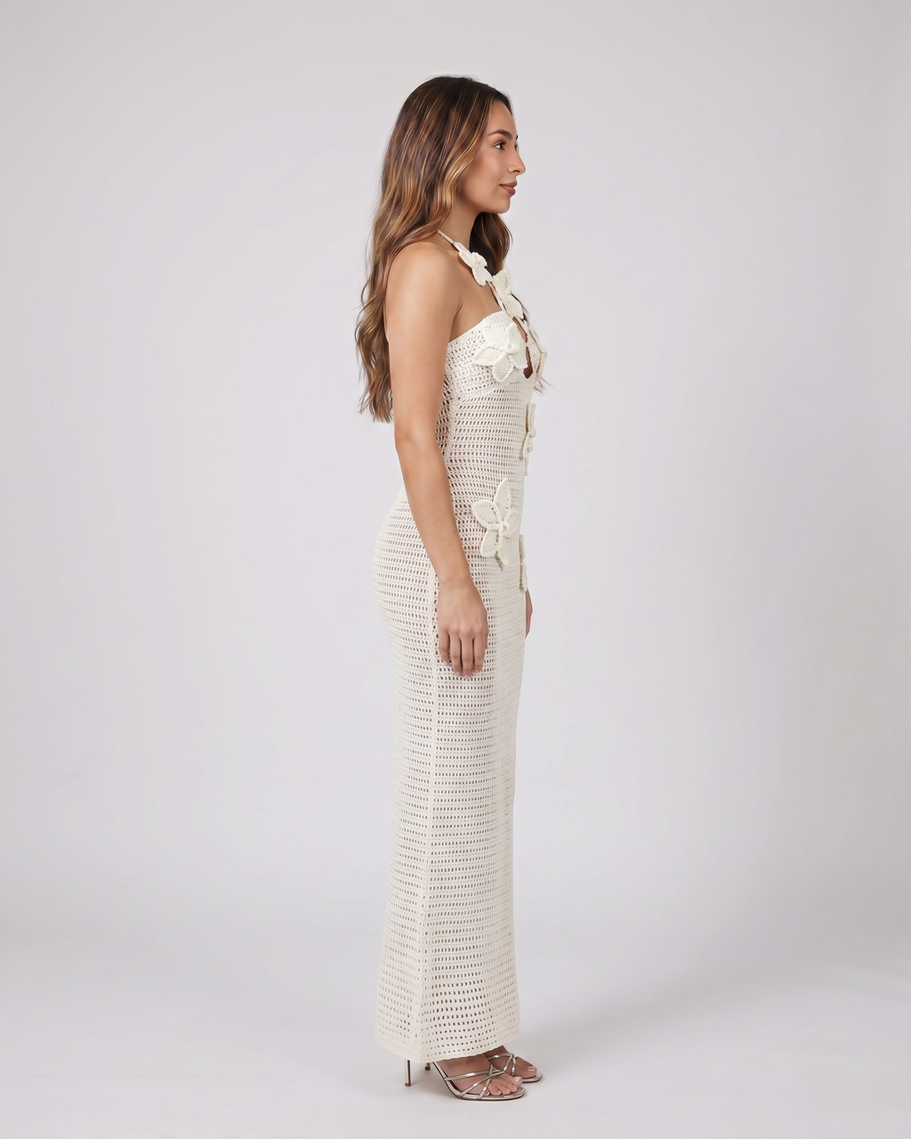 Side view of ivory halter floral applique crochet maxi dress