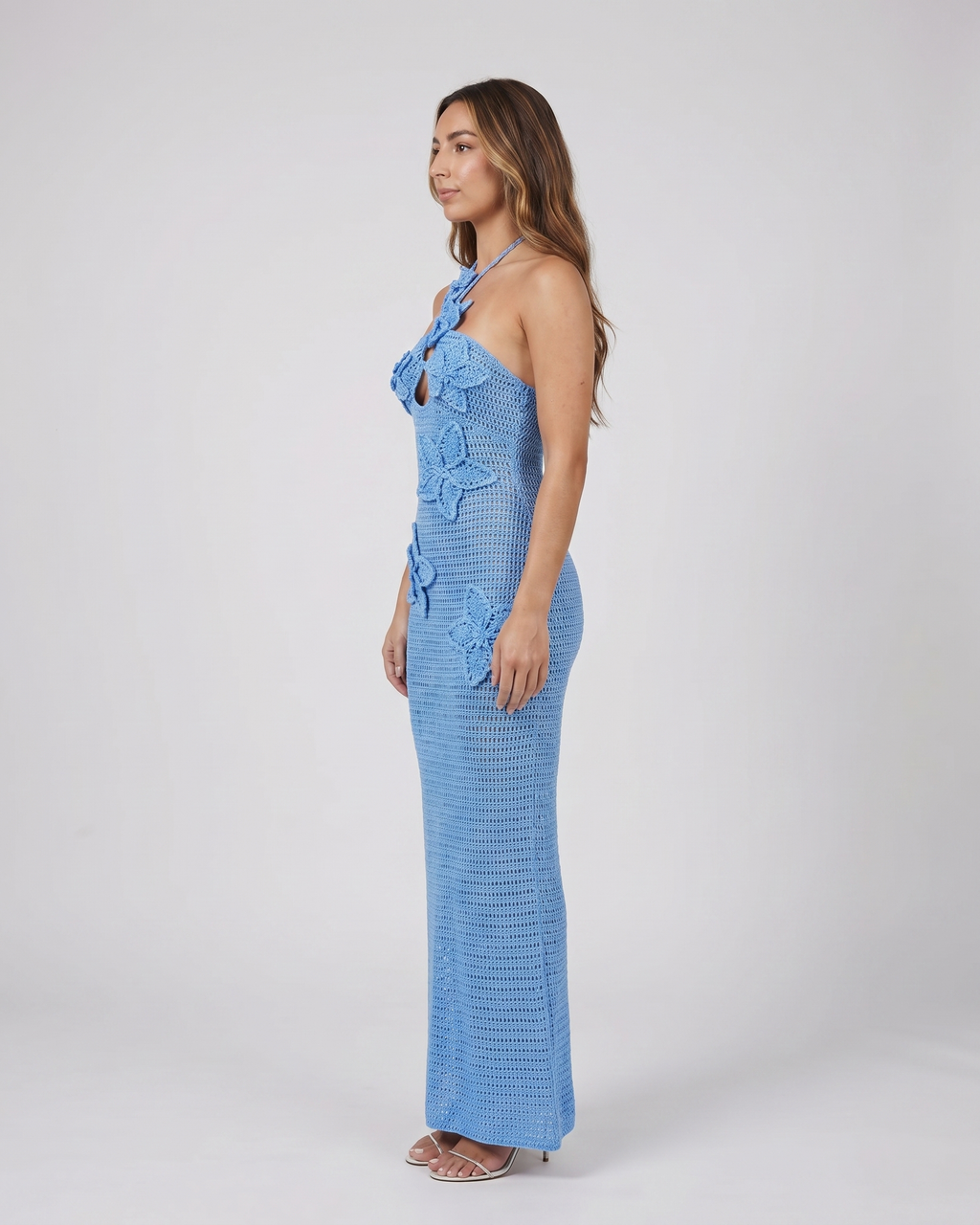 Side view of blue halter floral applique crochet maxi dress