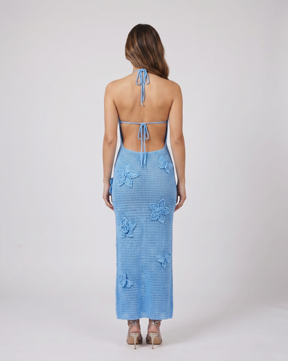 Back view of blue halter floral applique crochet maxi dress showing open back with halter tie-back
