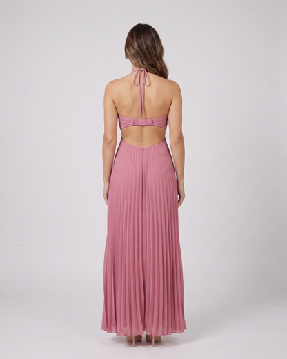 Back view of pink halter pleated with cutout maxi dress showing open back with horizontal mid-back strap and criss-cross tie straps at lower back