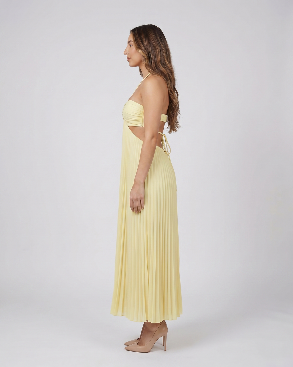 Side view of light canary halter pleated with cutout maxi dress