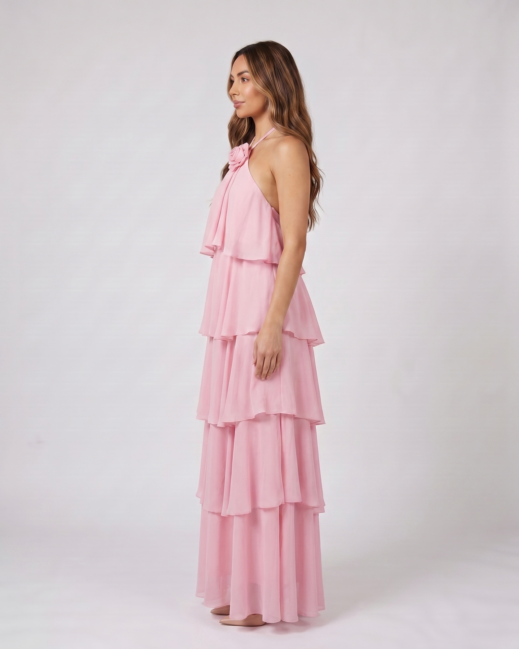 Side view of pink halter rosette tiered maxi dress