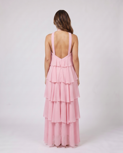 Back view of pink halter rosette tiered maxi dress showing deep V-open back with wide halter straps