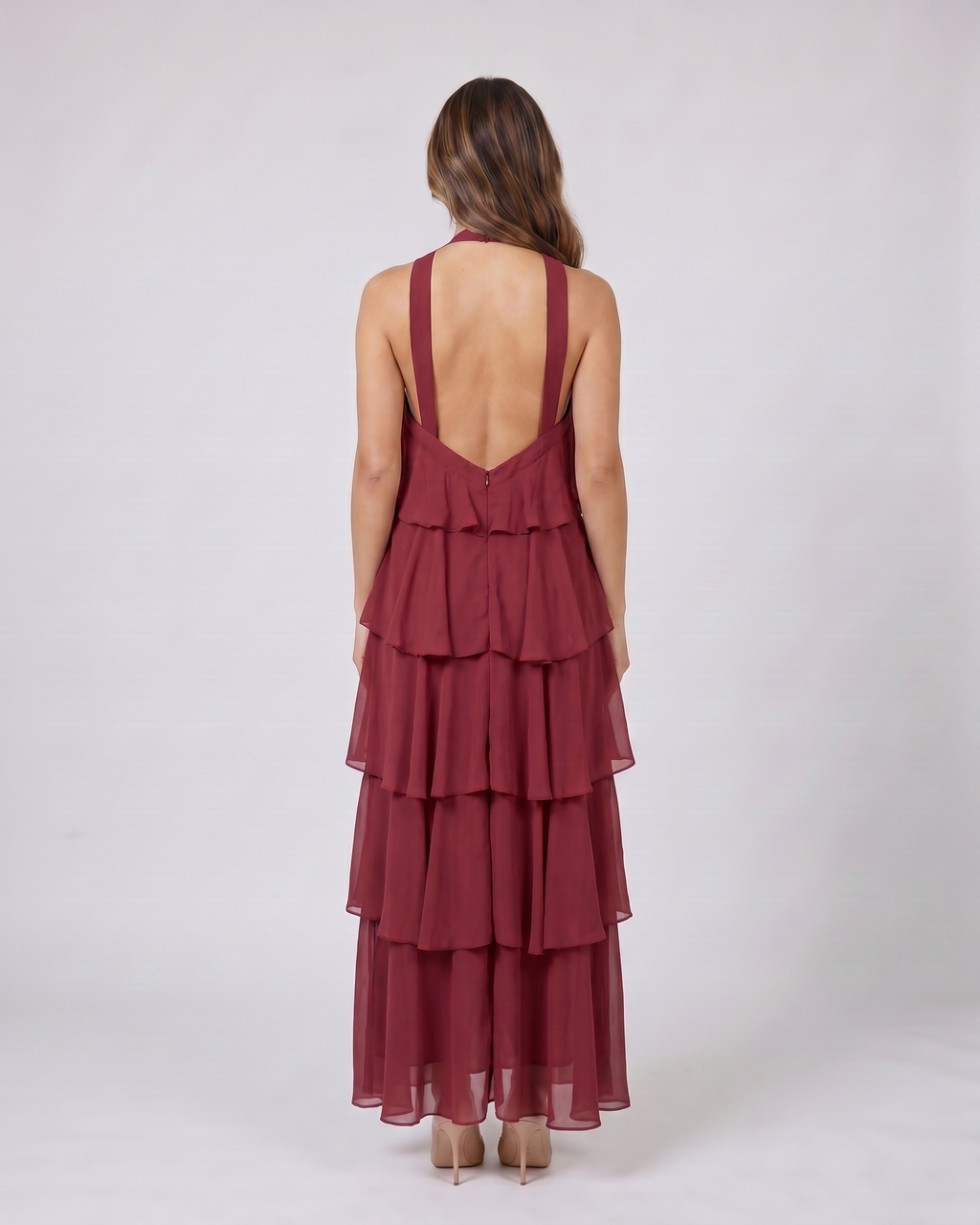Back view of red halter rosette tiered maxi dress showing deep V-open back with wide halter straps
