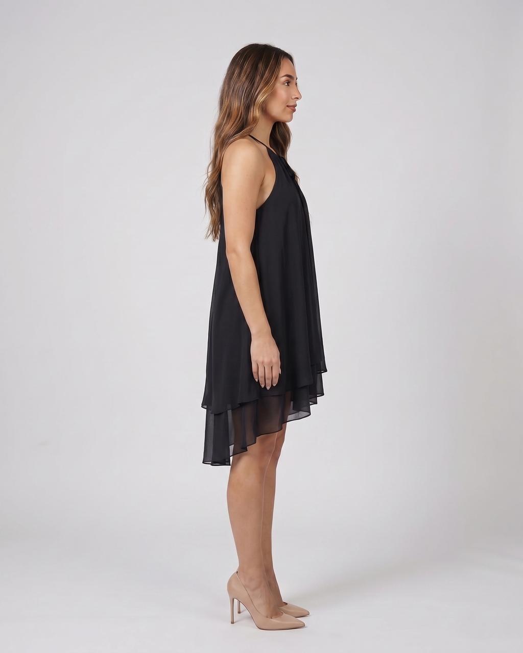 Side view of black halter sleeveless asymmetric mini dress