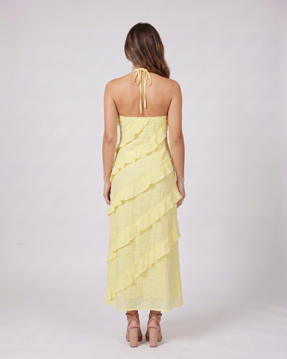 Back view of lemon halter v neck tiered ruffle maxi dress showing open back with halter tie closure