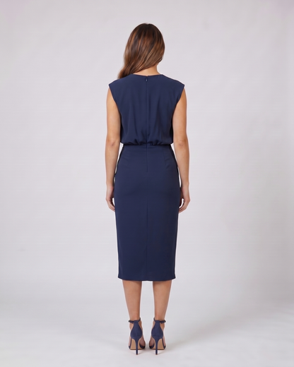 Back view of navy blue keyhole neck ruched side midi dress showing solid back